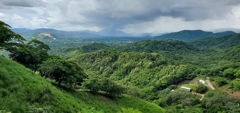 Green season landscape of the Nicoya mountains with clouds over the valley, Guanacaste, Costa Rica