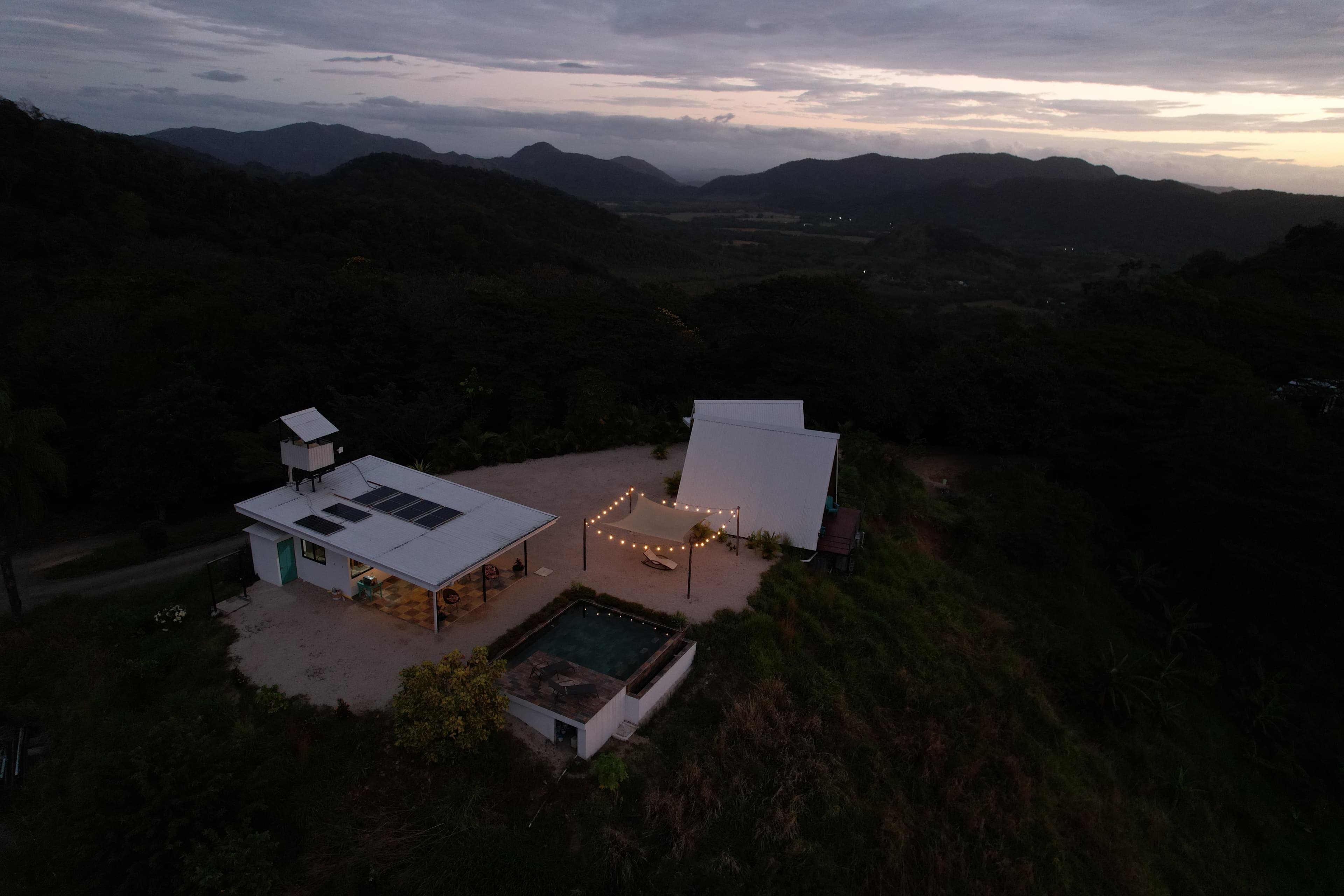 Night illuminated luxury vacation rental Bluesky Lodge infinity pool exclusive Costa Rica mountain retreat