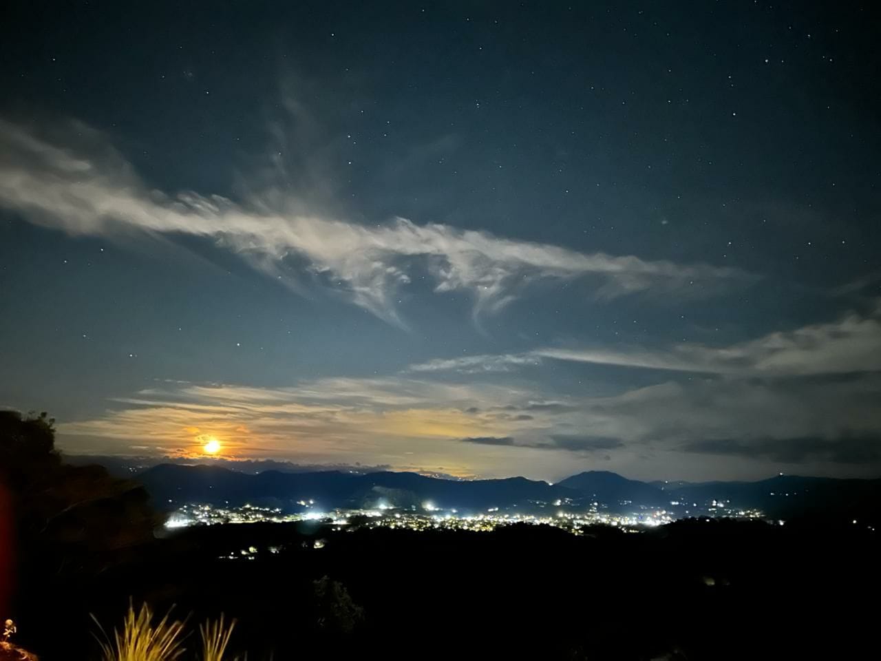 Spectacular panoramic night view from Bluesky Lodge with valley lights and starry sky in the Blue Zone mountains