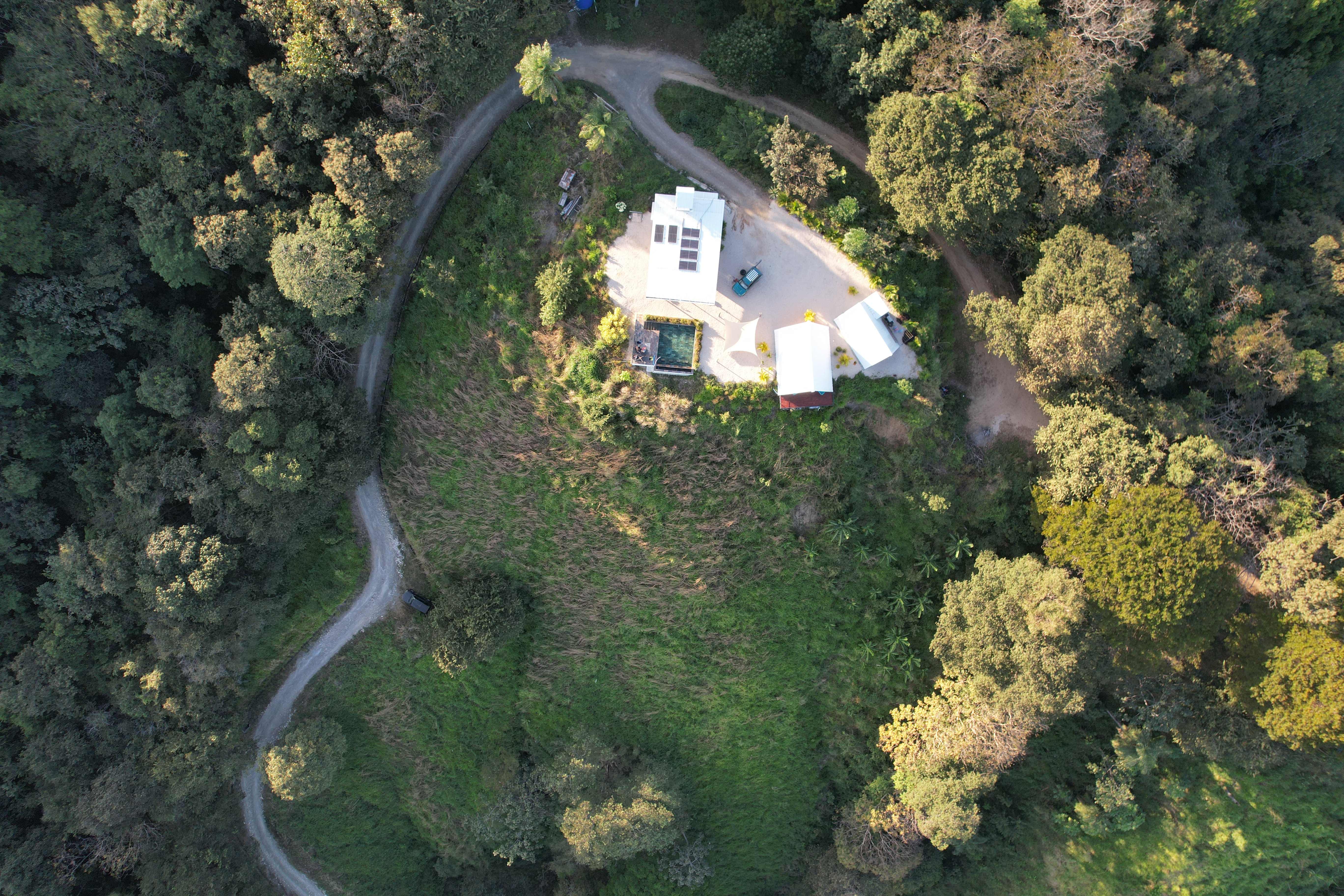Top aerial view showcasing the exclusive lodge design and winding roads in the Blue Zone