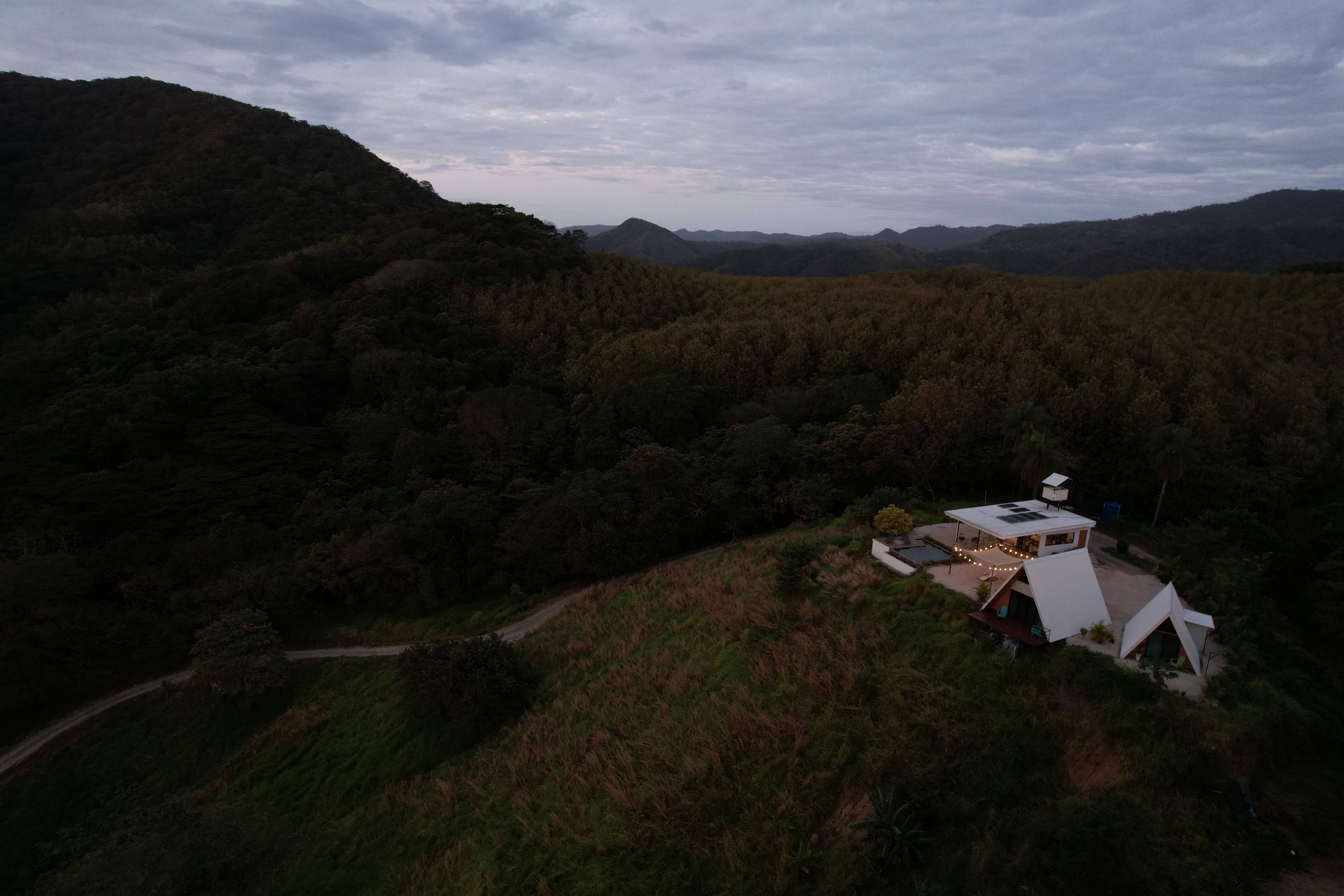 Dramatic sky aerial view of Bluesky Lodge at night, an exclusive vacation destination
