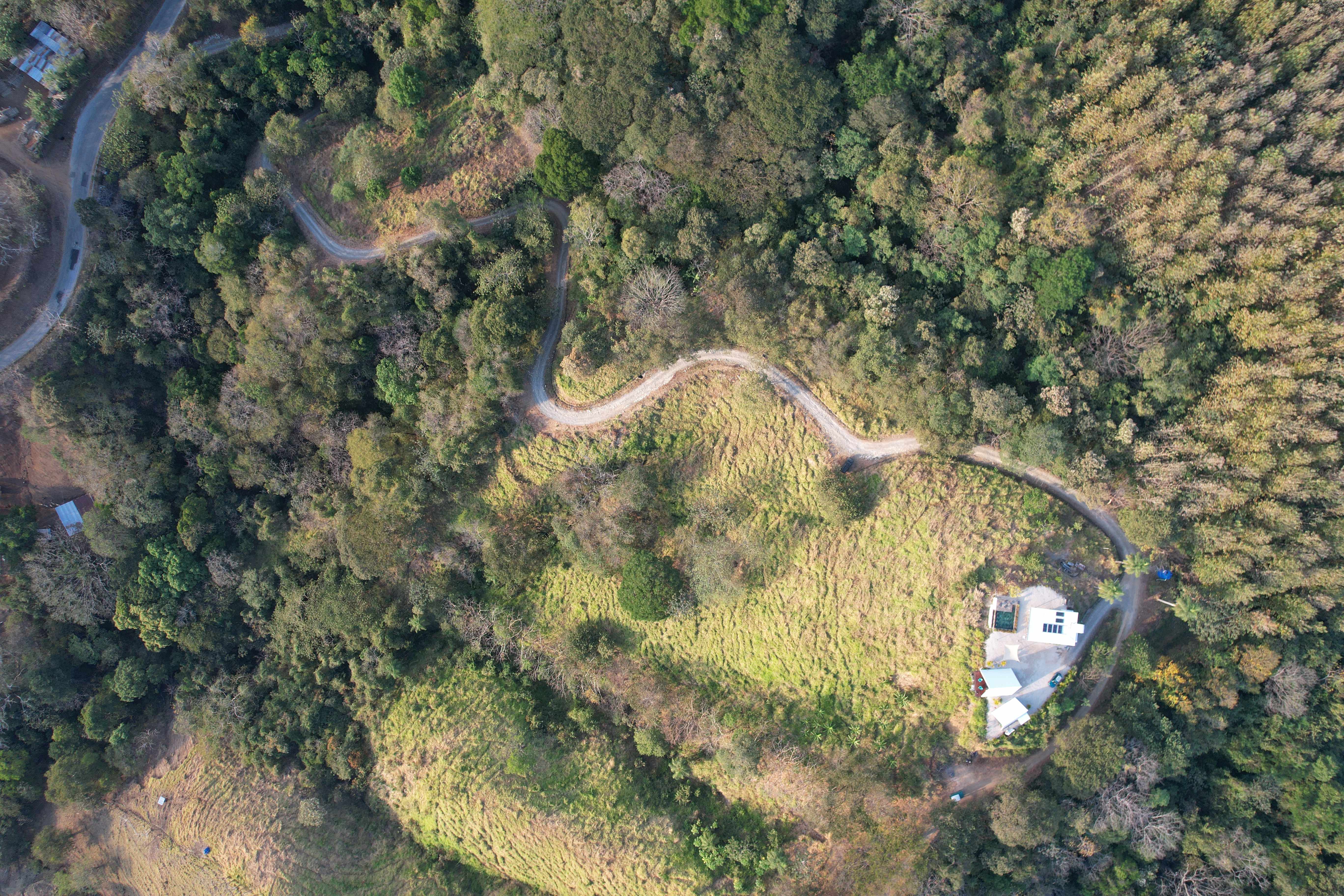 High altitude aerial view showing the winding road leading to the exclusive Bluesky Lodge